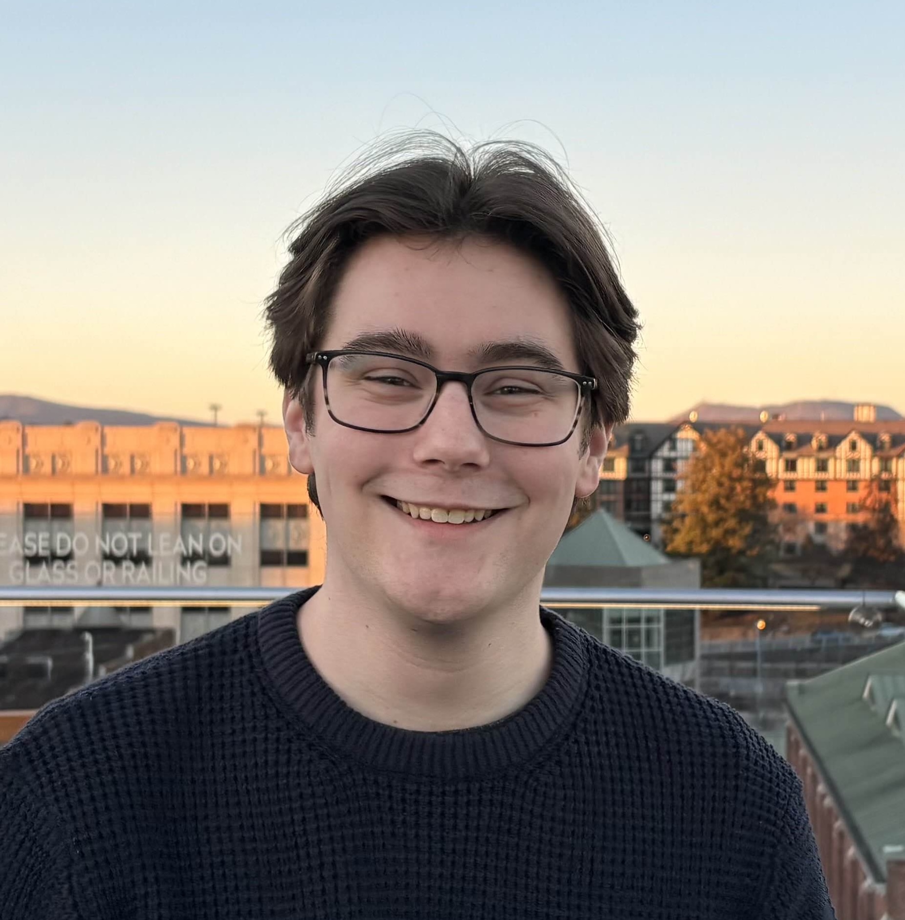 Cameron on a rooftop looking at the camera